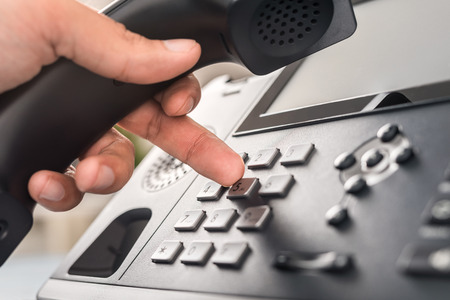 Communication support, call center and customer service help desk. VOIP headset on laptop computer keyboard.の写真素材