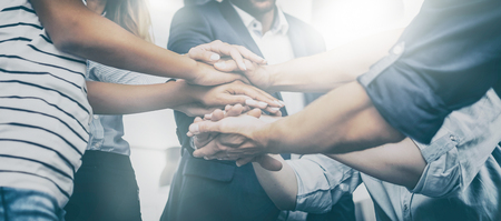 Close up view of young business people putting their hands together. Stack of hands. Unity and teamwork concept.の写真素材