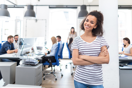 Portrait of young confident woman leader standing in office. New start up business concept.の写真素材