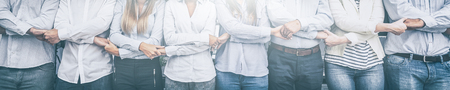 Creative team meeting hands together in line. Young business people are holding hands. Unity and teamwork concept.の写真素材
