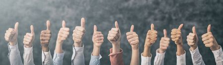 Hands showing the thumb and the symbol ok. Concept of winning people, winners.の写真素材