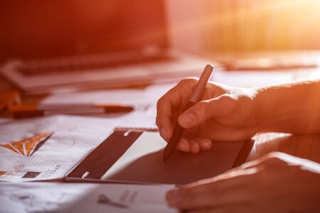 Graphic designer drawing sketches logo design. The concept of a new brand. Professional creative occupation with idea.の写真素材