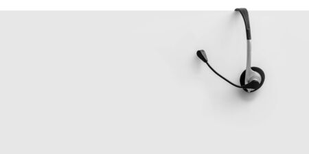 Communication support, call center and customer service help desk. VOIP headset on yellow wall background.の写真素材