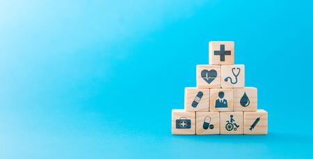 Hand arranging wood block with healthcare medical icon. Health insurance - concept.の写真素材