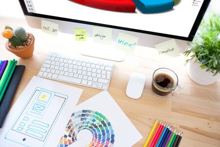 Professional web design and website development service: computer with web page layout project and desktop work toolsの写真素材
