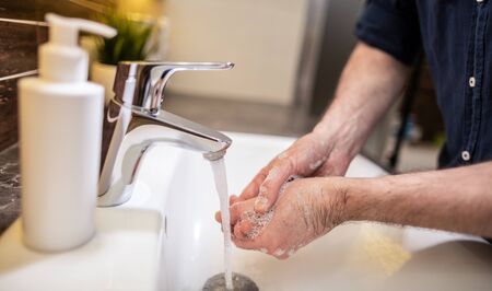 Washing hands with soap and hot water. Prevention coronavirus. Corona Virus (covid 19) pandemic protection by washing hands.の写真素材