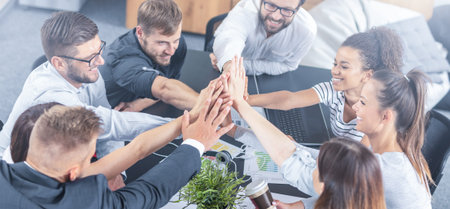Business people happy showing team work and giving five in office. Teamwork concepts.