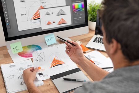 Graphic designer drawing sketches logo design. The concept of a new brand. Professional creative occupation with idea.の写真素材