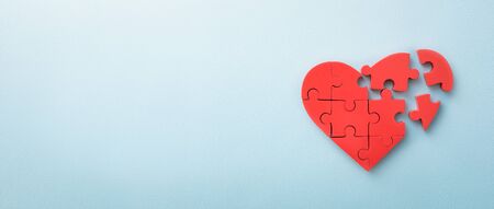 The concept of charity, love, donate and helping hand. International cardiology day. Red heart on blue background.の写真素材