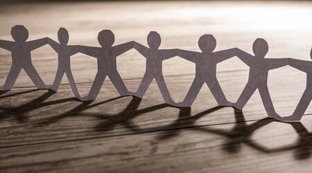Team of paper chain people. Human chain with light and shadow.の写真素材