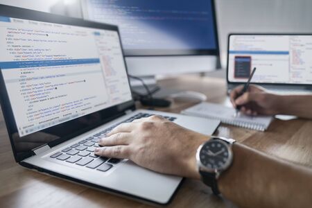 Developing programming and coding technologies. Website design. Programmer working in a software develop company office.の写真素材