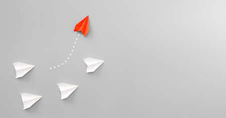 New ideas creativity and different innovative solution. Business concept. A group of paper airplanes, one plane is flying in the other direction, different way.の写真素材