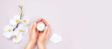 Woman applying moisturizing cream on hands. Cosmetic cream lotion concept.の写真素材
