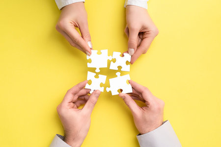 The man and woman holds in hand a jigsaw puzzle. Business solutions, success and strategy concept.