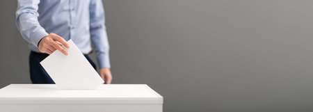 The voter holds his vote ballot paper and places it in the ballot box. Filling in ballots and...