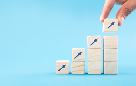 Hand arranging wood block with arrow up icon. Business concept growth success process.の写真素材