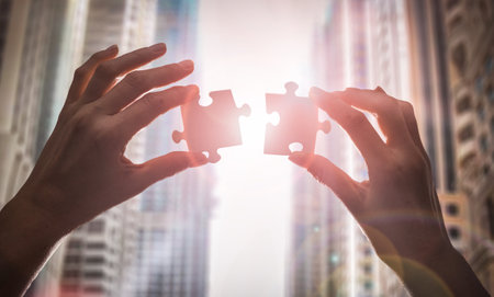The man holds in his hand a jigsaw puzzle. Business solutions, success and strategy concept.の写真素材