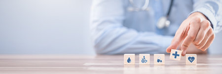 Hand arranging wood block with healthcare medical icon. Health insurance - concept.の写真素材