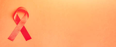 Red ribbon symbol of awareness AIDS and HIV disease. International World AIDS Day.の写真素材