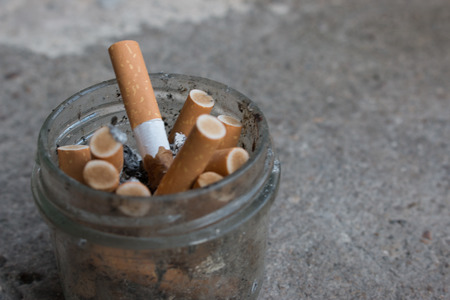 cigarettes in a transparent glass close-upの写真素材