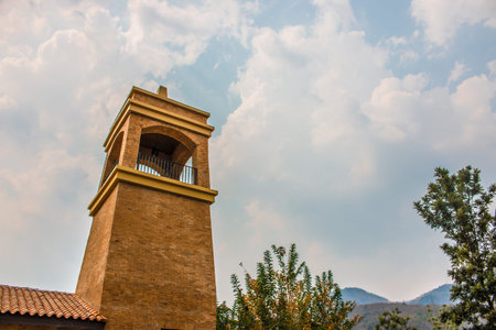 Brick watch tower with clear sky and cloud covered by the mountains