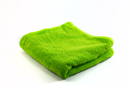 Green towel handkerchief isolated on white background closeupの写真素材