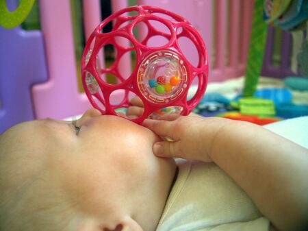 3 month baby discover a new toyのeditorial素材