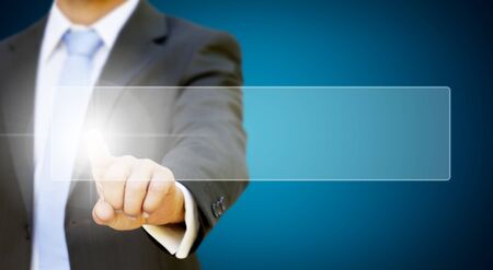 Businessman pressing digital screenの写真素材