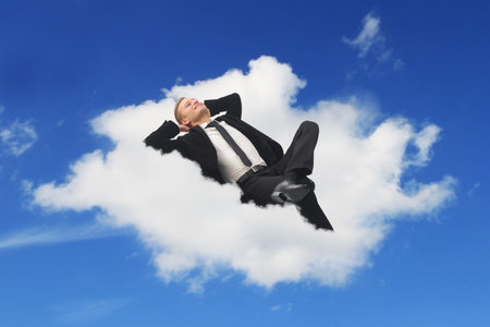 Businessman sleeping in a cloud dreaming about his holidays