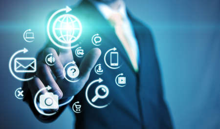 Businessman using multimedia interface with his fingersの写真素材