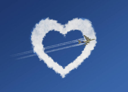 Fluffy love clouds on blue sky backgroundの写真素材