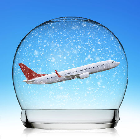 Snowball travel concept with a plane representing holidaysの写真素材