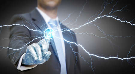 Businessman with a robot hand using a digital interfaceの写真素材