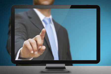 Businessman using tablet multimedia with his fingersの写真素材