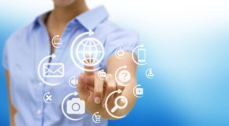 Businesswoman using digital interface with her fingersの写真素材