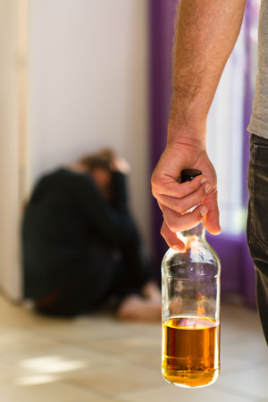 Man beating up his wife illustrating domestic violenceの写真素材