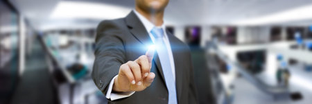 Businessman using digital interface with his fingers in his officeの写真素材