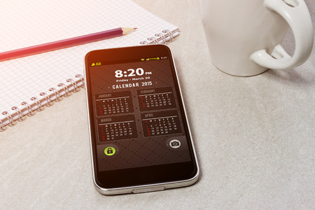 Workplace with mobile phone on table close-upの写真素材