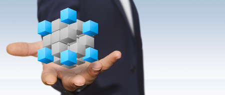 Businessman holding digital cube in his handsの写真素材