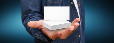 Businessman holding white business card in his handの写真素材