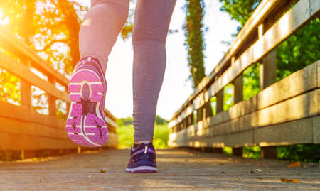 Fitness Girl running in a field with colorful outfitの写真素材