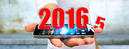Man holding 2016 icons for the new yearの写真素材