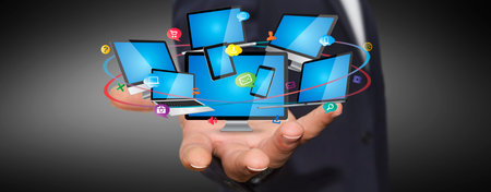 Businessman holding multimedia tech devices in his hand
