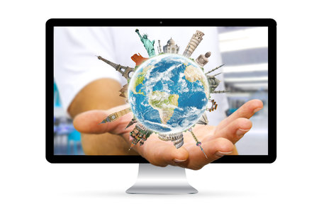 Businessman going out of a computer screen with planet earth and landmarks flying over his hands