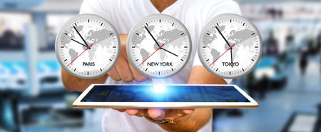 Businessman holding three big white timers from different countries over his digital tablet