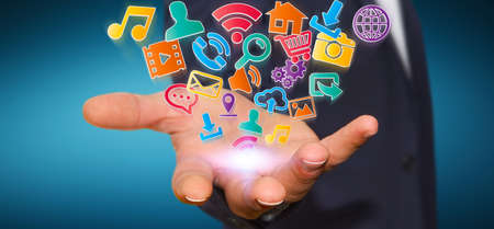 Young businessman holding modern digital icon application in his handの写真素材