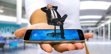 Man holding a businessman in his hand having a break