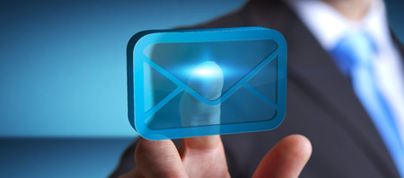 Businessman holding a digital 3D email icon in his handの写真素材