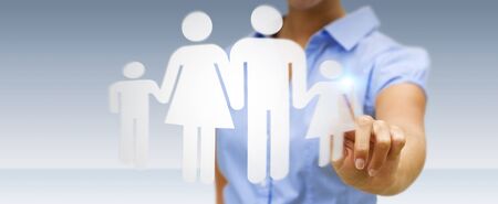 Businesswoman holding family icon in his handの写真素材