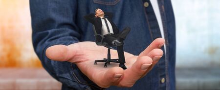 Man holding a businessman in his hand having a breakの写真素材